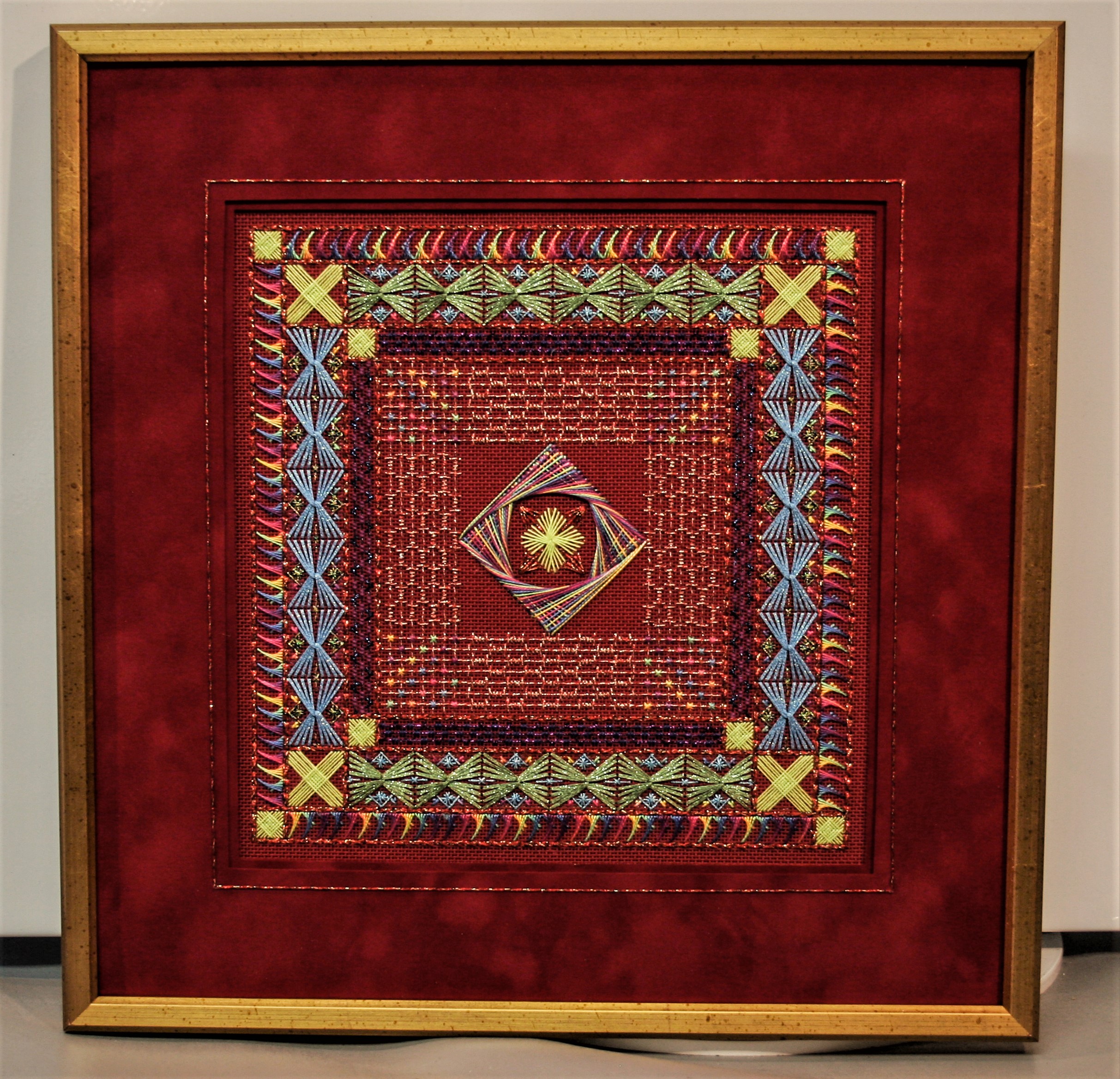 Framed specialty stitch needlepoint with gold line and velvet embellished mat